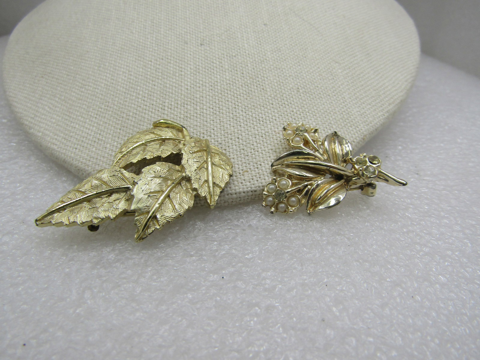 Vintage Pair of Gold Tone Leaf & Floral Brooches, 1960's: Vintage Pair of Gold Tone Leaf and Floral Brooches, 1960's, Two brooches, one is textured four leaf brooch with shiny stem and leaf veins down the center. It is and is 1.75" by 1.25". The second is a 