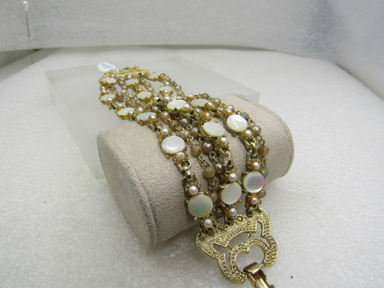 Vintage 7 Strand Mother-of-Pearl Bracelet, Gold Tone, 7": Vintage 7 Strand Mother-of-Pearl Bracelet, Gold Tone, 7" and appx. 1.5" wide. This has three strands of appx 1/3" round mother-of-pearl disks and faux pear beaded strands. Four strands are all faux pe