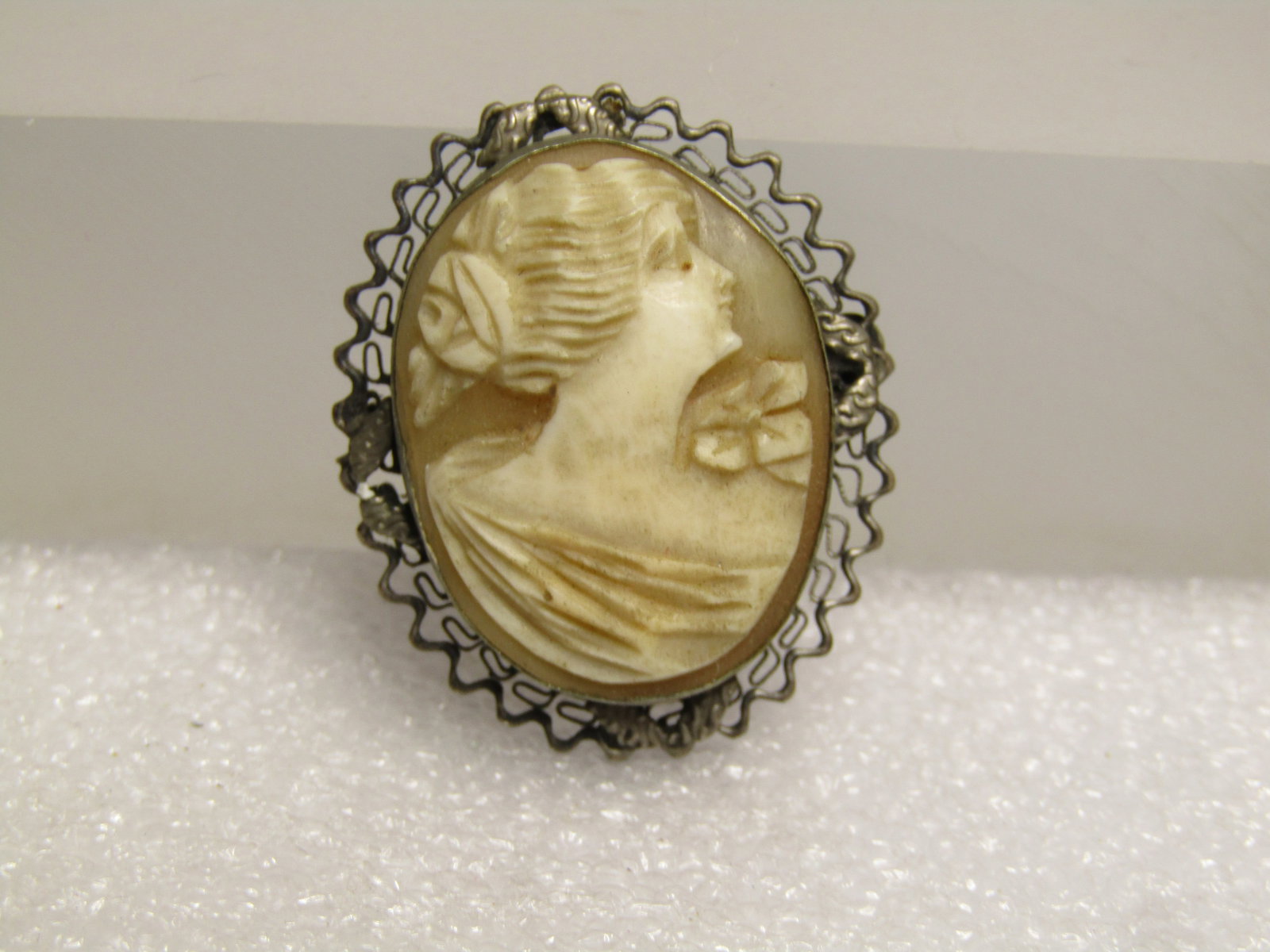 Vintage Sterling Cameo Brooch, 1920's-1930's: Vintage Sterling Cameo Brooch, 1920's-1930's. This is appx. 1.25" tall and 1" wide with a zigzag filigree base. It tests as sterling with a weight of appx. 4.23 grams. It has a locking clasp. The came