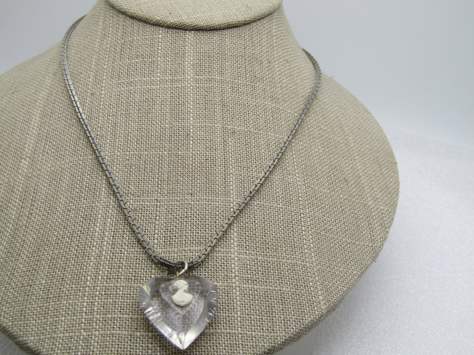 Vintage Clear Heart Cameo Necklace, 17.5", 1960's: Vintage Clear Heart Cameo Necklace, 17.5", 1960's. This has a lucite clear heart pendant with a white molded cameo on the short table seton top. The heart with jump ring is 1.25" tall and 1" wide. It 
