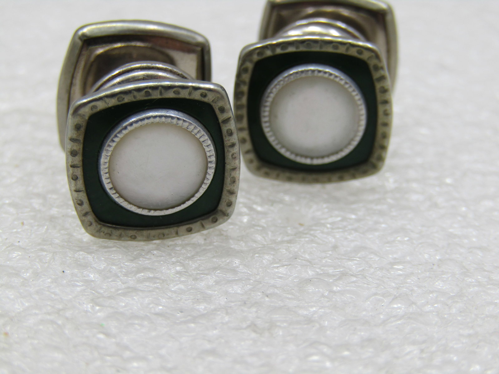 Vintage Snap Link Green Enamealed MOP Cufflinks: Vintage Snap Link Green Enameled MOP Cufflinks. Deep green enameled cufflinks with a bezel-set center mother-of-pearl round insert. Notched design around the frame. The cufflinks look the same front a