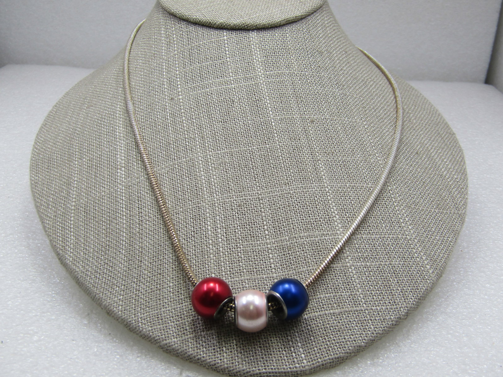 Red, White, & Blue Pearly Slide Bead Serpentine Necklace, 20": Red, White, & Blue Pearly Slide Bead Serpentine Necklace, 20". Paraiotic Vintage - has a .925 tag howerver this does not test as sterling. 2.5mm round serpentine chain with lobster clasp. The beds