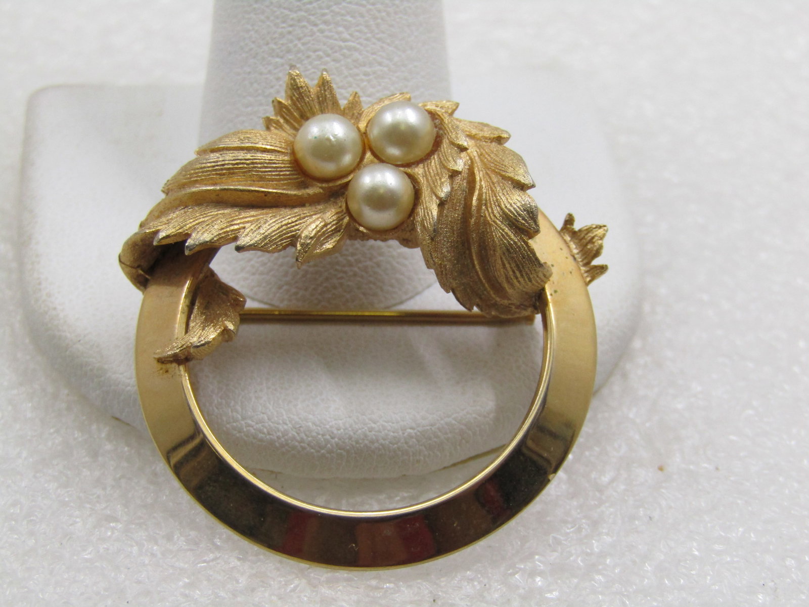 Vintage Faux Pearl & Leaf Circle Brooch, Sarah Coventry: Vintage Faux Pearl & Leaf Circle Brooch, Sarah Coventry, 1960's-1970's. Gold tone 1.5" at the top swag that drapes over the brooch. Three 4.5mm faux pearls centered in the center of the swag of leaves