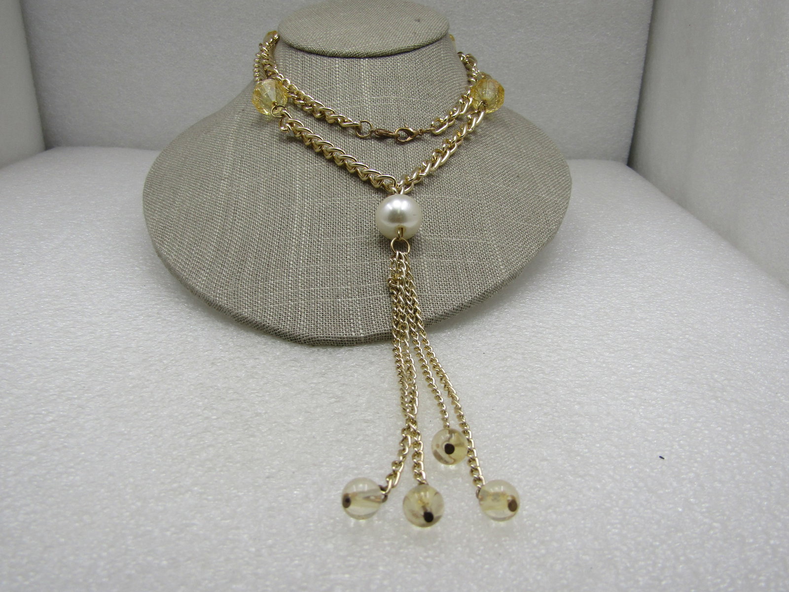Vintage Faux Pearl Yellow Crackle Tassel Necklace, 28": Vintage Faux Pearl Yellow Crackle Tassel Necklace, 28" with a 15mm white faux pearl at the top of the tassel and that drops measures an additional 5". Gold done, The curb link chain is appx 6.5mm.
