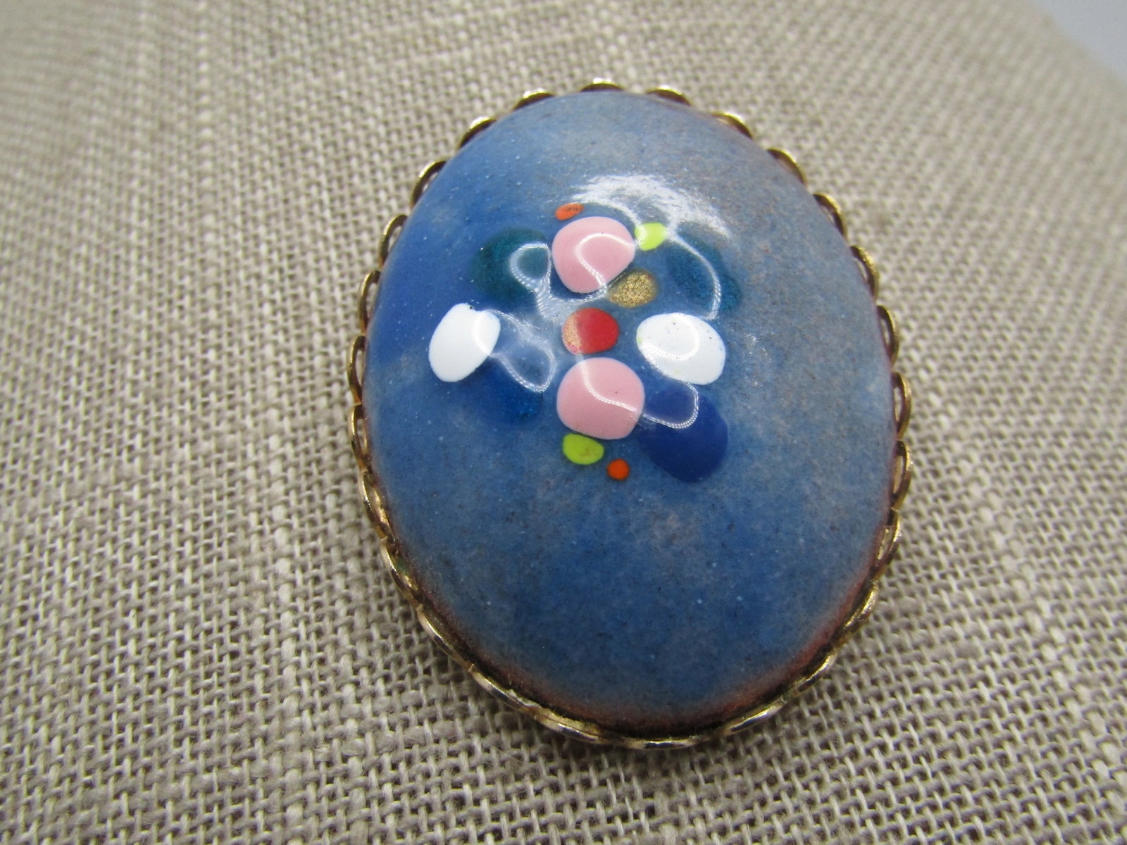 Vintage Ceramic Blue Domed Brooch, Cameo Style, Hand Made, 1960's: Vintage Ceramic Blue Domed Brooch, Cameo Style, Hand Made, 1960's. This has a scalloped bezel with a ble background and on the domed pink, red, dark blue, gold, yellow, orange drips of paint are