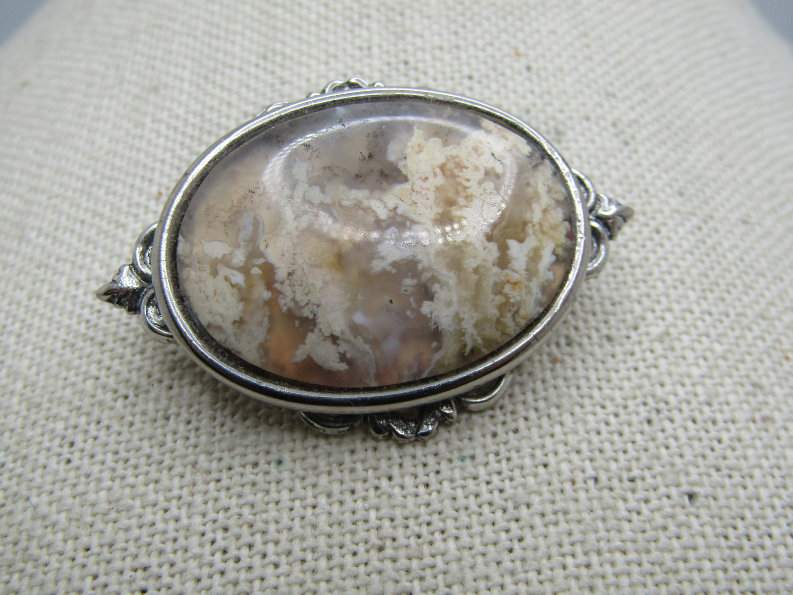 Vintage Agate Like Cameo Style Brooch, 1970's-1980's: Vintage Agate Like Cameo Style Brooch, 1970's-1980's. It is oval shaped and looks like a clear agate with white inclusions. It is not plastic - could be glass or could be an agate. It has a filigree b