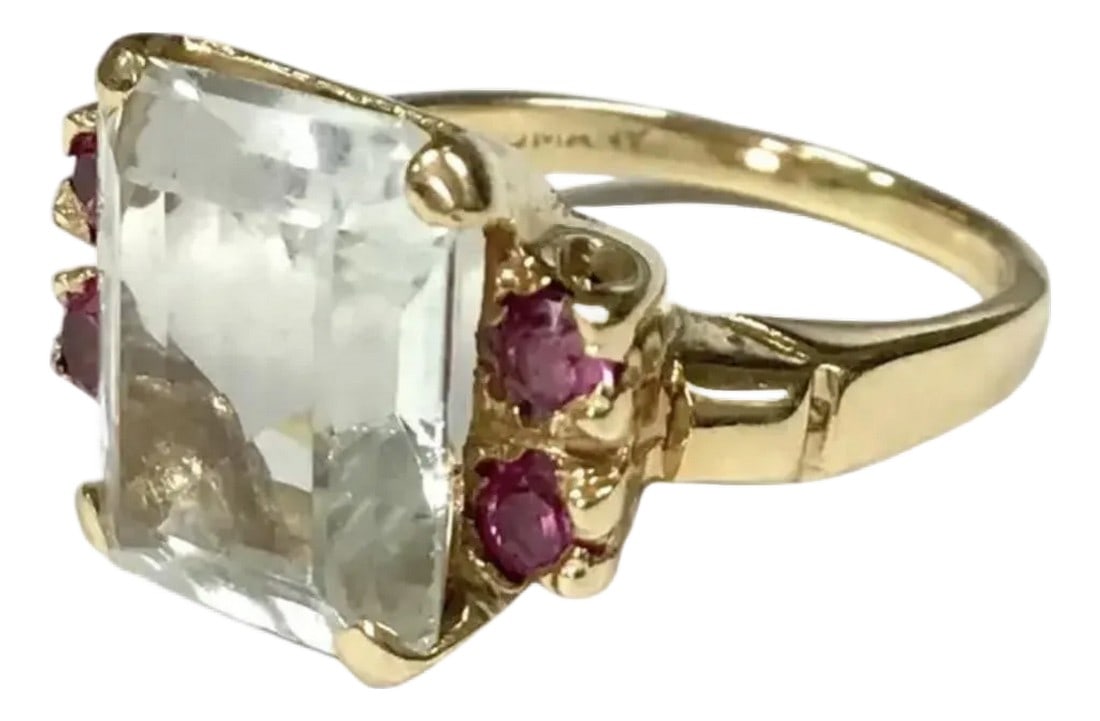 Aquamarine and Ruby Ring 14k Yellow Gold: 14K Yellow Gold, Aquamarine And Ruby Ring, size 6. Emerald cut aquamarine centered by four matching round pink rubies. Aquamarine approximately 5 carats. Condition: Alterations: Original Condition Una