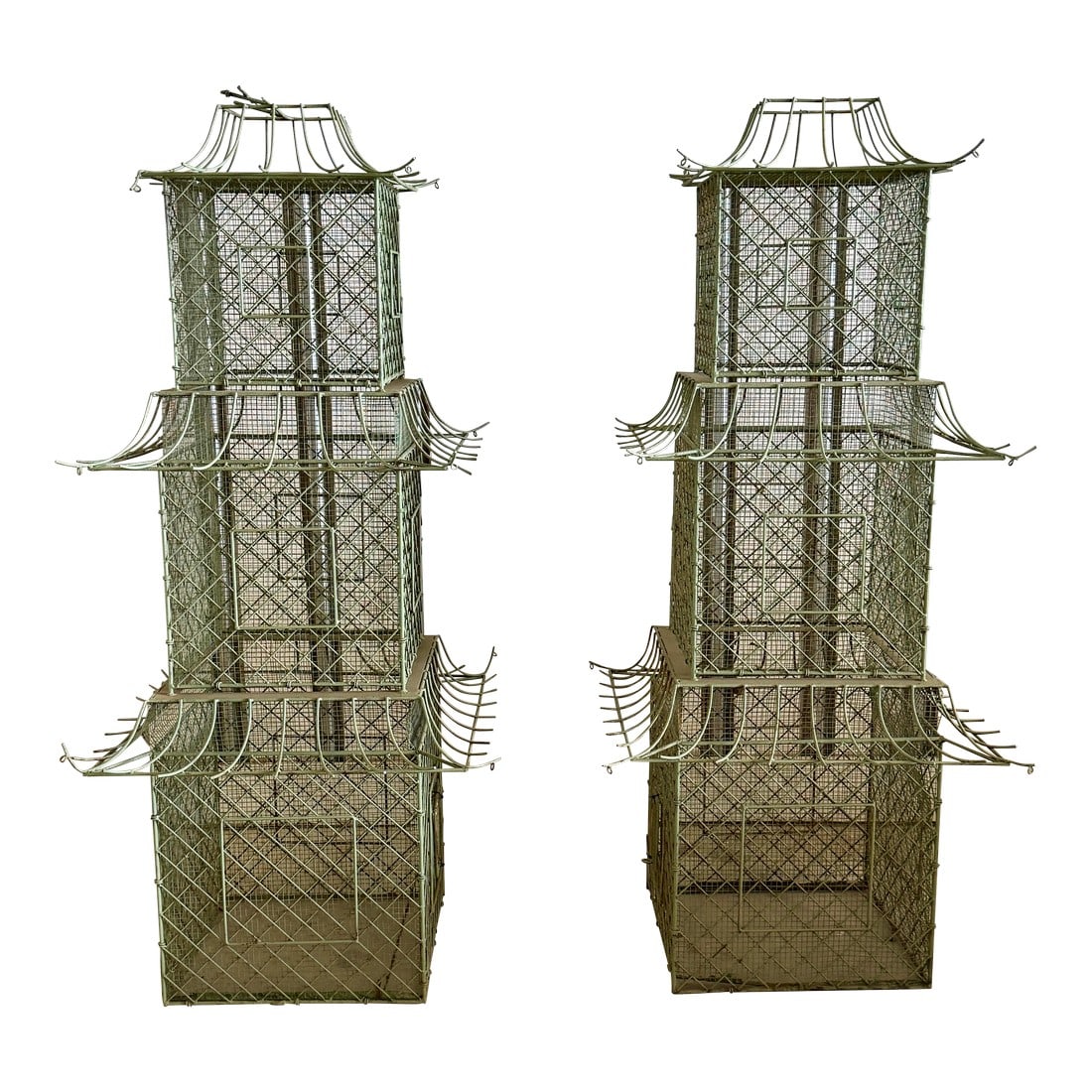 Pair of Monumental Chinoiserie Style Painted Iron Pagoda-Form Birdcages: An exceptional and highly decorative pair of monumental iron birdcages, each finely modeled in the form of a multi-tiered Chinese pagoda, dating to the mid-to-late 20th century. These towering