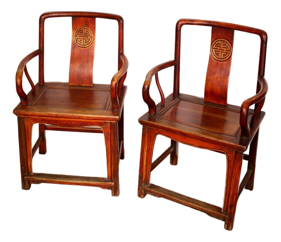 19th Century Ming Style Oxblood Finish Pair of Double Longevity Chairs: Pair of hand-carved elmwood longevity/scholar chairs in the Ming era style with an oxblood finish, bentwood arms, and curved back support featuring a circular carved detail. Wax "CUSTOMS B02" seal on