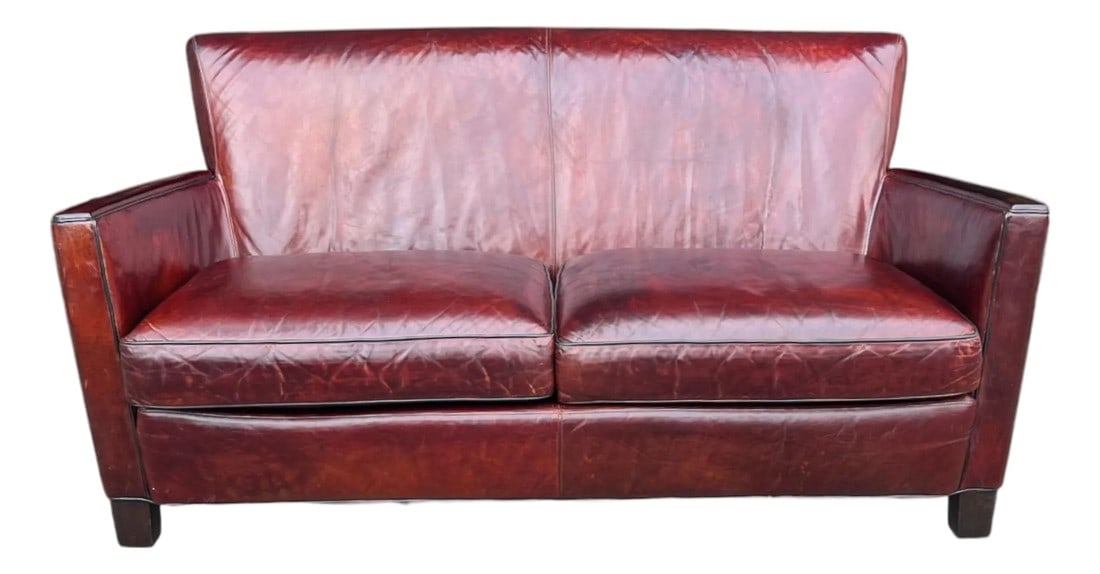 Rich Burgundy Vintage Leather Sofa With Beautiful Patina & Timeless Form - By Crate and Barrell: This elegant vintage leather sofa embodies timeless craftsmanship and refined, understated design. Upholstered in rich, hand-dyed leather, the piece features a deep burgundy tone with beautiful variat