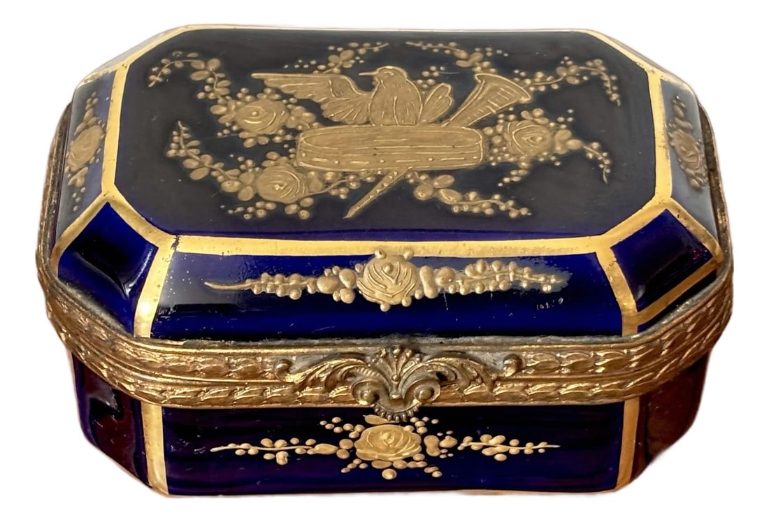 Antique French Sevres Style Porcelain Jewelry Casket Dresser Trinket Box: Very fine French Sevres style jewelry casket. Mid to late nineteenth century. Unsigned by its maker. Hinged lid and sides decorated with raised gold bird and florals on a dark cobalt blue ground.