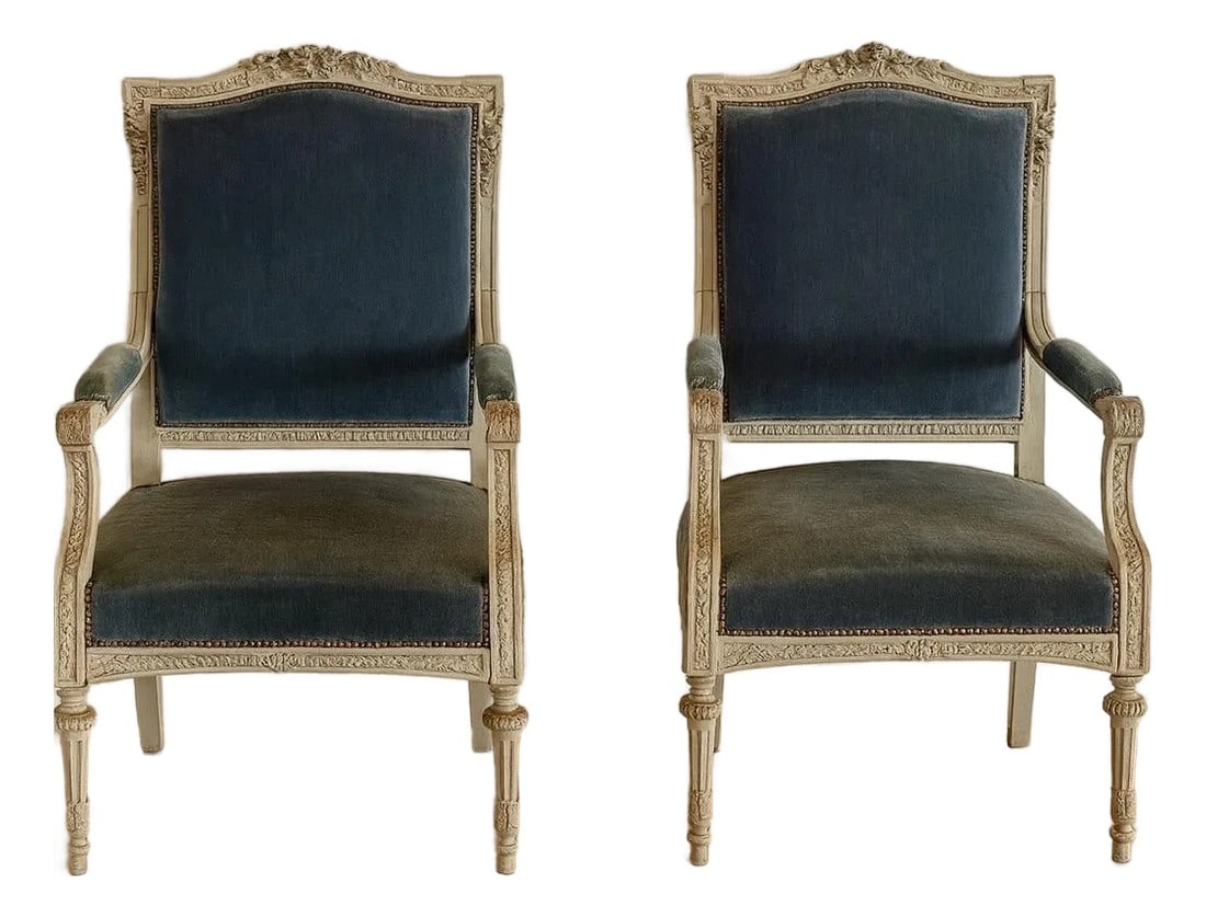 Pair of Louis XVI-style (Neoclassical) French Arm Chairs, Late 19th Century: Elegant pair of French Louis XVI-style armchairs from the late 19th century. These chairs embody the timeless grace of the Louis XVI era, featuring beautifully distressed painted frames, hard-carved