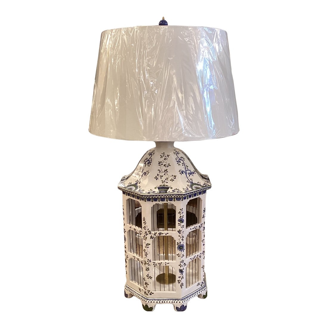 Italian Majolica One of a Kind Hand Painted Birdcage Table Lamp: One-of-a-kind custom table lamp in a sculptural birdcage form, hand-painted with delicate florals in soft blue and green. The octagonal body features open cage panels with a brass interior stem,