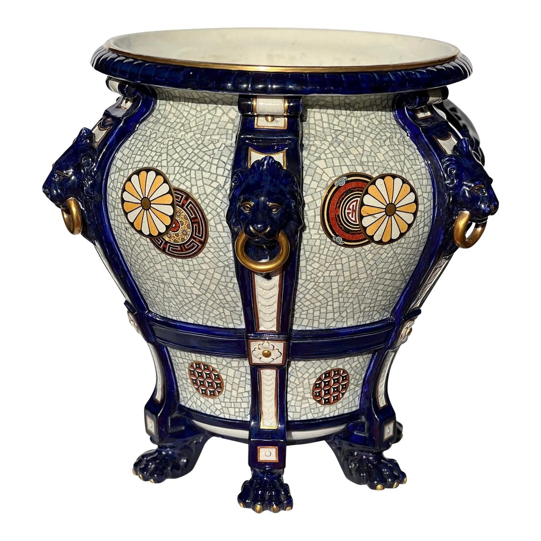 19th Century Vintage Minton Majolica Lion Head Handled Ascetic Jardiniere: A 19th century Minton Majolica cobalt blue ground jardinieÌ€re. The baluster shaped jardinieÌ€re has six pilasters applied with lion mask and ring handles and stands on paw