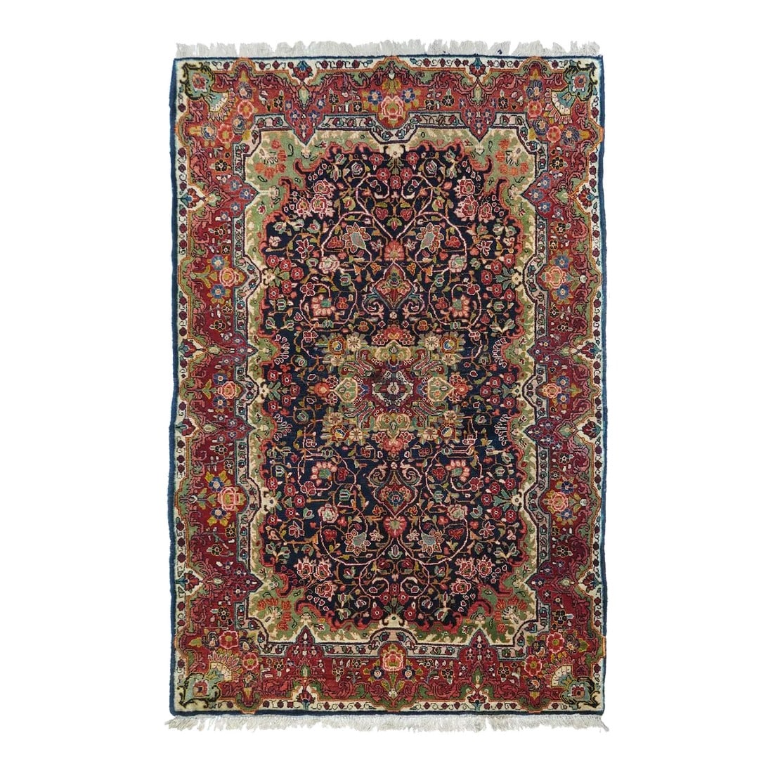 Vintage Sarouk (One of Pair) Rug 4'4'' X 6'10'': This vintage, west Persian rustic scatter features a notched and flaming rectangular navy sub-field with a four palmette octogrammoidal medallion centred on a wine red rosette. Staccato ecru vinery. E