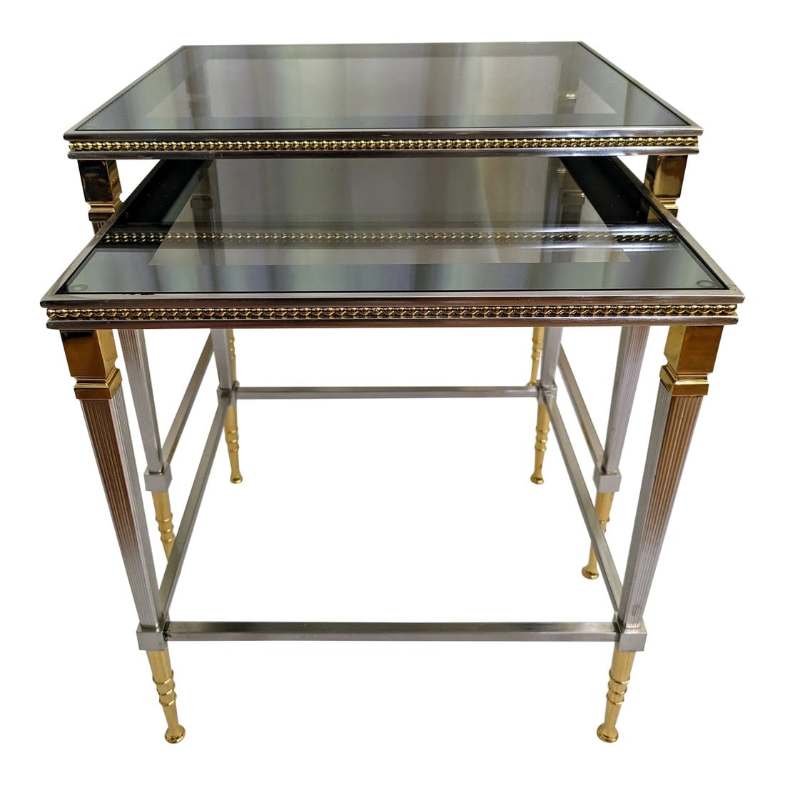 1970s Maison Baguès Nesting Tables, Set of Two: Two Steel and Brass Maison Baguès Style Nesting Tables 20th century, each with a rectangular smoked glass top, largest to smallest: H 18" X L 18" X D 14-3/4"; H 16-1/2" X L 15" X D 13-1/2". *One