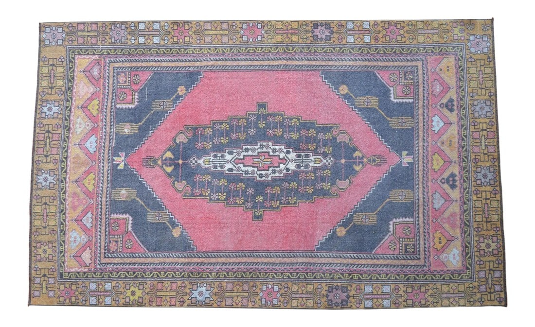 Distressed Area Rug Hand Knotted Colorful Low Pile Oushak Rug - 4'5'' X 7'3'': This is a beautiful vintage hand knotted distressed finish Rug from Turkey. It has faded primary colors on a desaturated pink field . This rug would be an easy to work with in just about any setting. 
