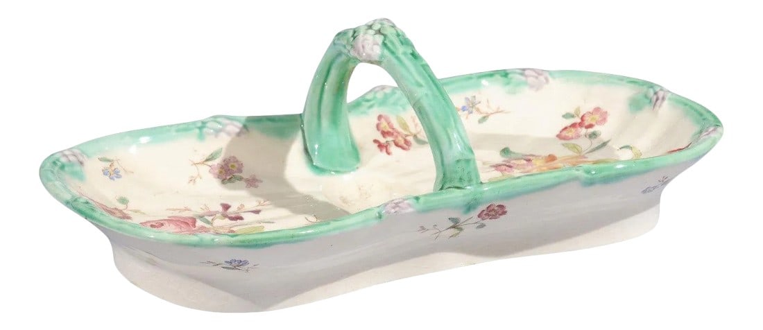 French 19th Century Longchamp Majolica Asparagus Server with Floral Decor: A French Longchamp Majolica asparagus server from the 19th century, with floral decor and C-scroll handle. Born in France during the 19th century, this lovely Majolica asparagus server features a curv