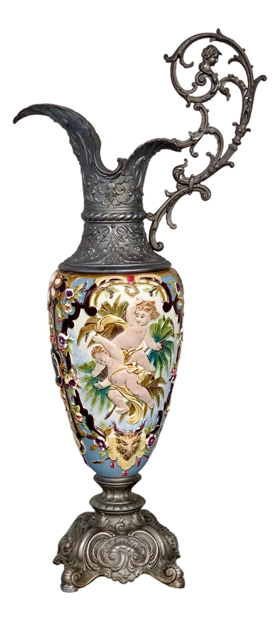 19th Century French Hand Painted Faience Ewer Vase: Pair of Sevres ewer-form mantel decorations, 19th century, hand-painted with scenes front and back, bronze mounts with cherubs at top and seashells around bases. Condition: Alterations: Unknown