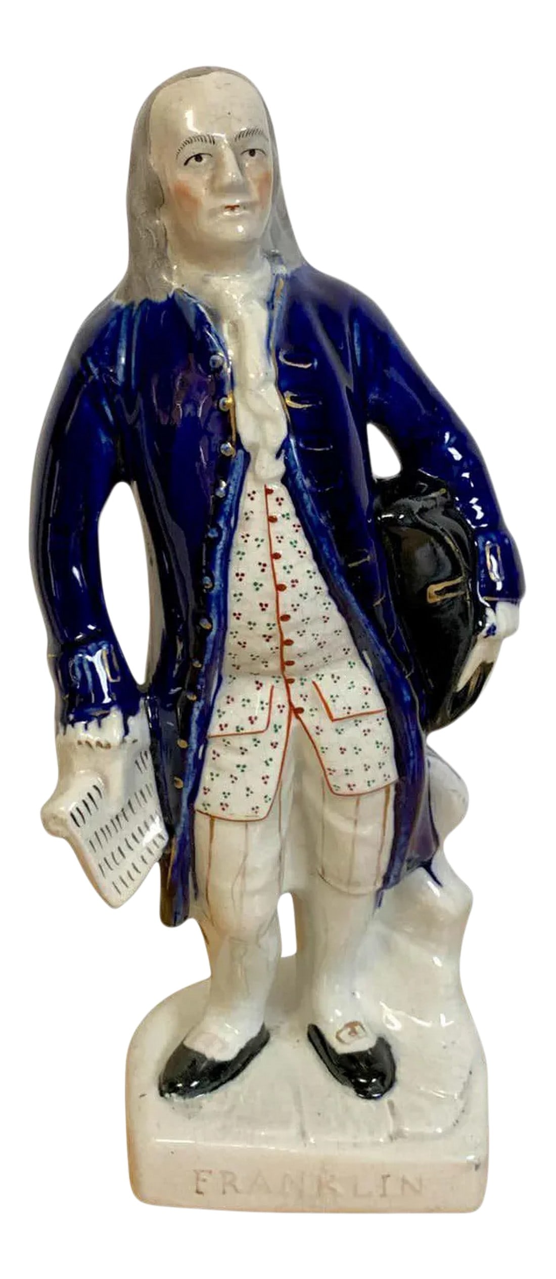 19th Century Staffordshire Portrait Figure of Standing Franklin: Staffordshire portrait figure of standing Franklin, Circa 1850 Depicting Ben Franklin before a tree-stump, holding a tricorne hat against his left hip, a document in his right hand, wearing a blue coa