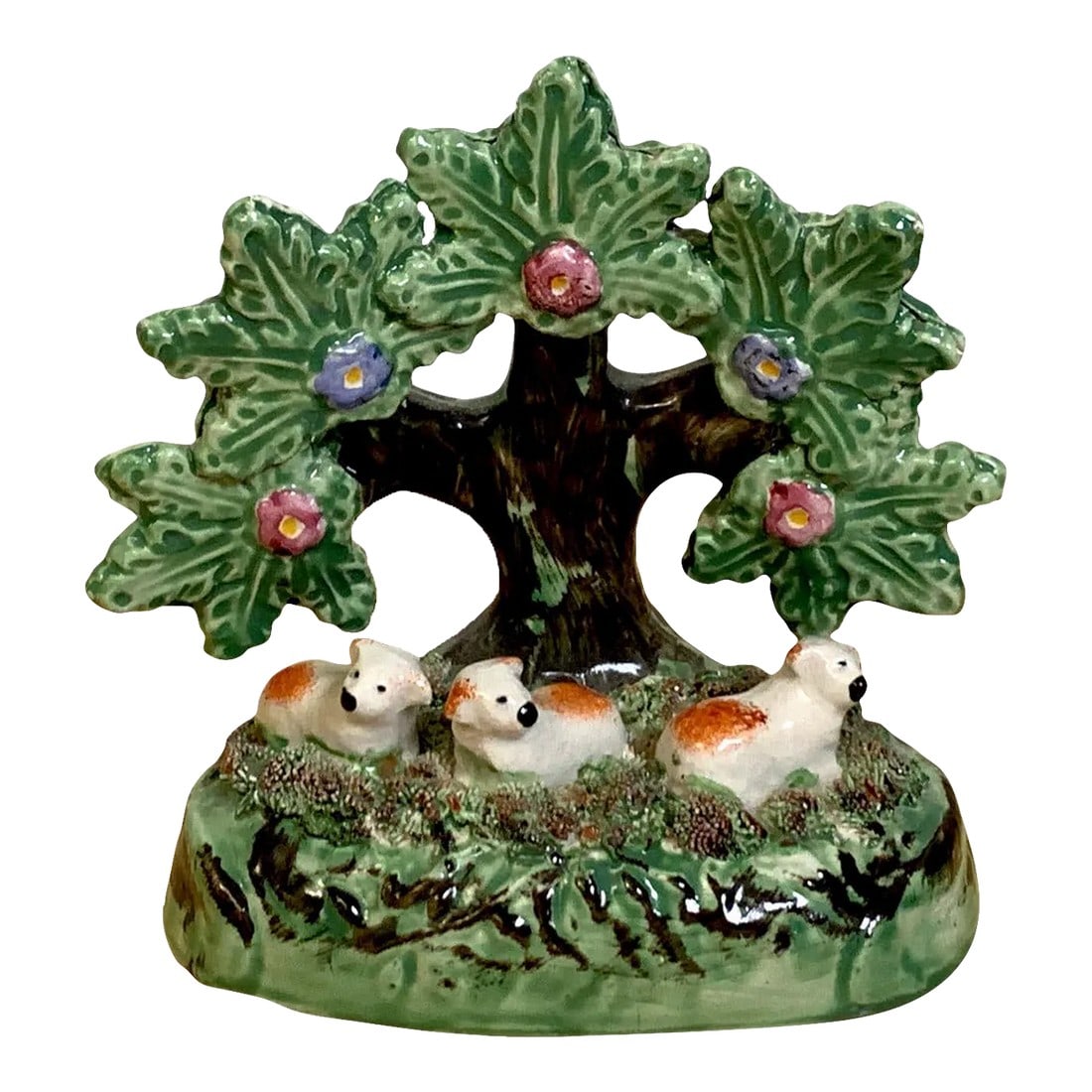 19th Century Staffordshire Pearlware Bocage Pack of Red Spaniel Puppies/ Sheep: Staffordshire Pearlware bocage pack of red spaniel puppies or sheep- A rare whimsical grouping of three seated red and white animals under a tree on an oval naturalistic base. Condition: Alterations: 
