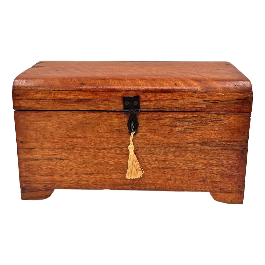 Early 20th Century Tiger Maple Rustic Footed Box With Domed Lid and Gold Tassel: Vintage footed wooden box features a black iron clasp, a gold tassel, and a slightly domed lid. Dating back to the early 20th century, this rustic box is believed to be made from tiger maple and has a