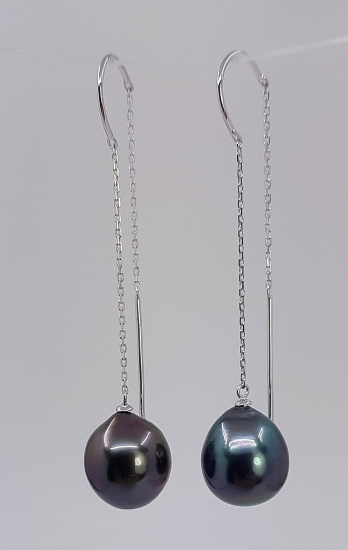 Earrings - 18 kt. White gold - 10x11mm Tahiti Pearls: Title: Earrings - 18 kt. White gold - 10x11mm Tahiti Pearls Description: Emerging from the tropical lagoons of French Polynesia, the pearls have a natural beautiful peacock colour with a rich luster. 