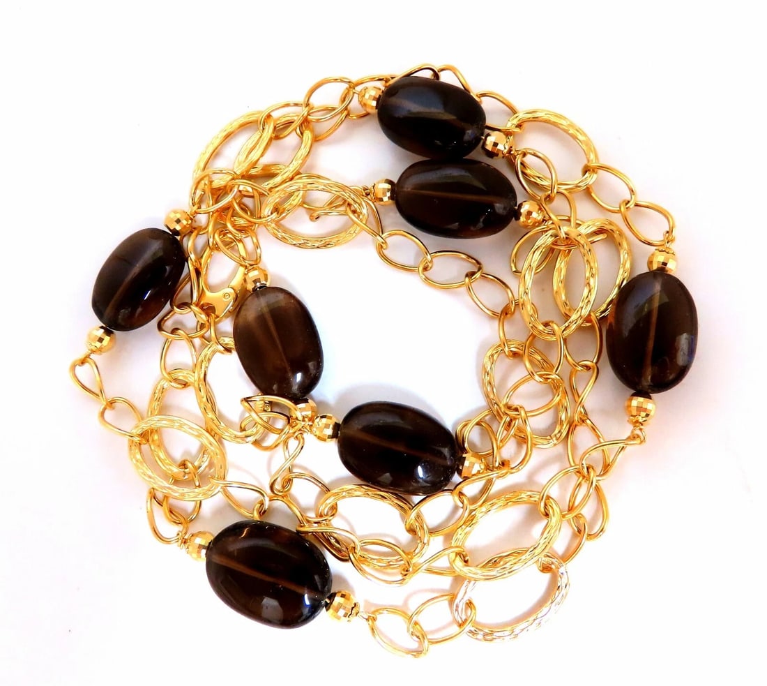 110ct Natural Topaz 14kt gold Necklace **: Title: 110ct Natural Topaz 14kt gold Necklace ** Description: MAGNIFICENT JEWELS 110ct Natural Topaz Necklace Cabachon oval cuts. Transparent 21 x 14mm 40 Inch Long 14kt. Yellow gold Grand weight: 52