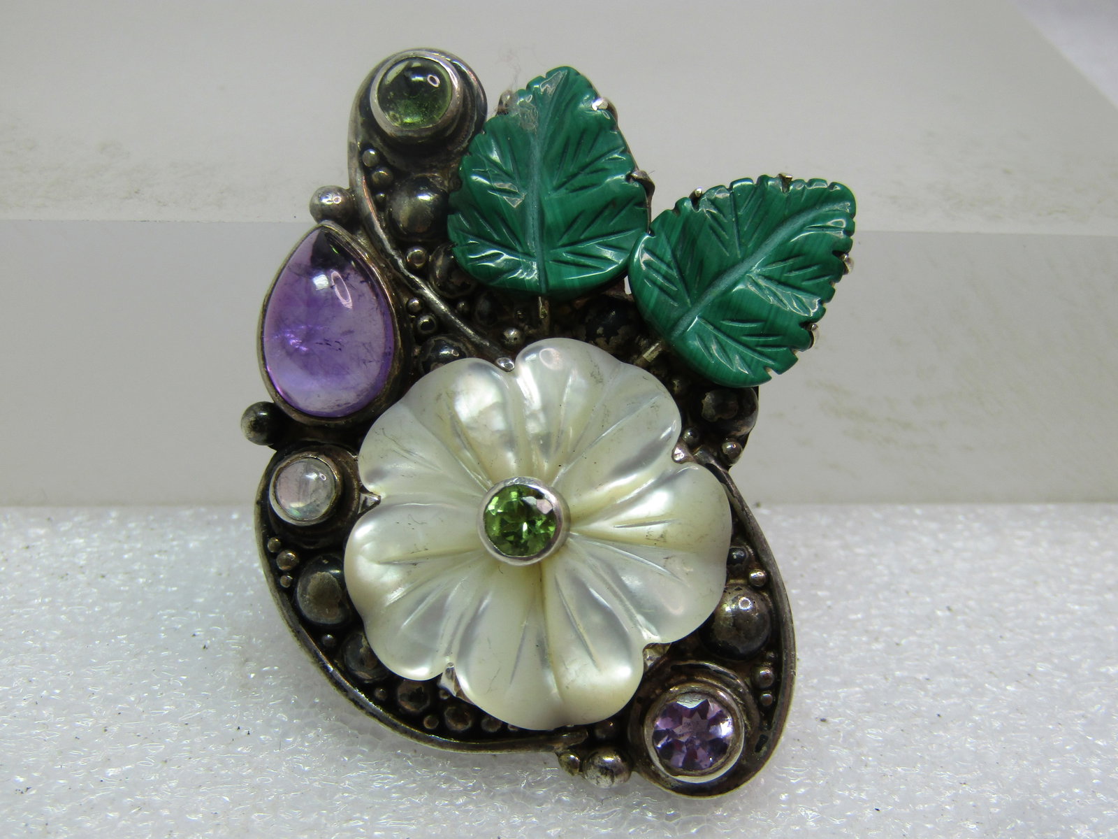 Vintage Sterling Floral/Leaves Brooch, Signed Sajen, 1980's-1990's: Vintage Sterling Floral/Leaves Brooch/Pendant, Signed Sajen, 1980's-1990's. Gorgeous brooch with a carved mother-of-pearl blossom, two green leaves and amethyst pear-shaped cabochon with a peridot;