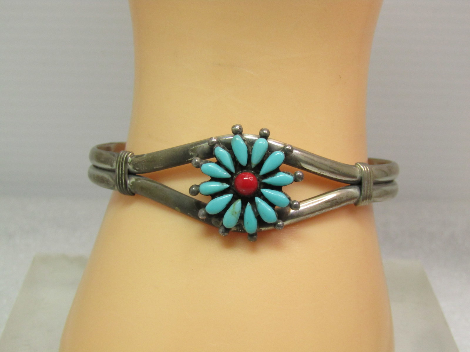 Vintage Southwestern Turquoise Red Coral Cuff Bracelet, 7", Zuni, 1970's-1980's: Vintage Southwestern Turquoise Red Coral Cuff Bracelet, 7", 1970's-1980's. This has a riased turquoise blossom design set on the top center with a red coral center. The bands of the bracelet are appx.