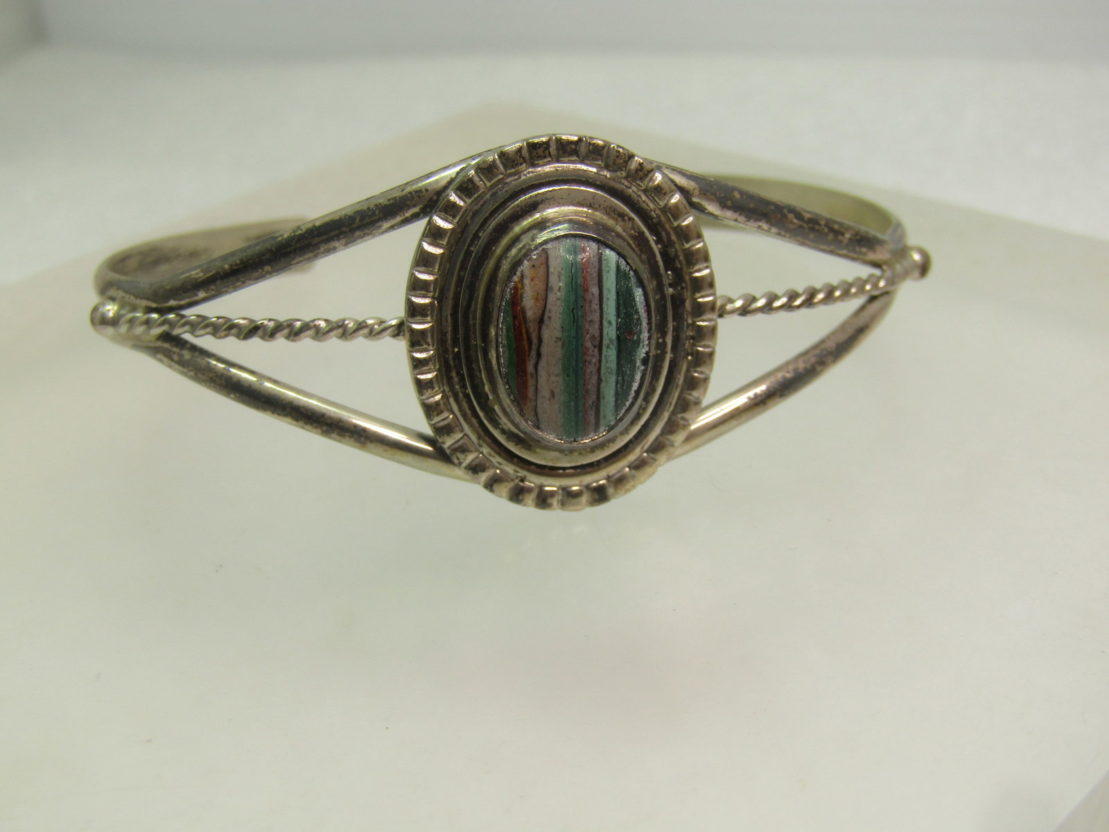Vintage Navajo Banded Agate Cuff Bracelet, Eugene Jackson, 1960's-1970's, 6.5": Vintage Navajo Banded Agate Cuff Bracelet, Eugene Jackson, 1960's-1970's, 6.5". This has a colorful banded agate that is appx. 14mm by 10mm oval that is bezel-set on a wider frame that has a deorative