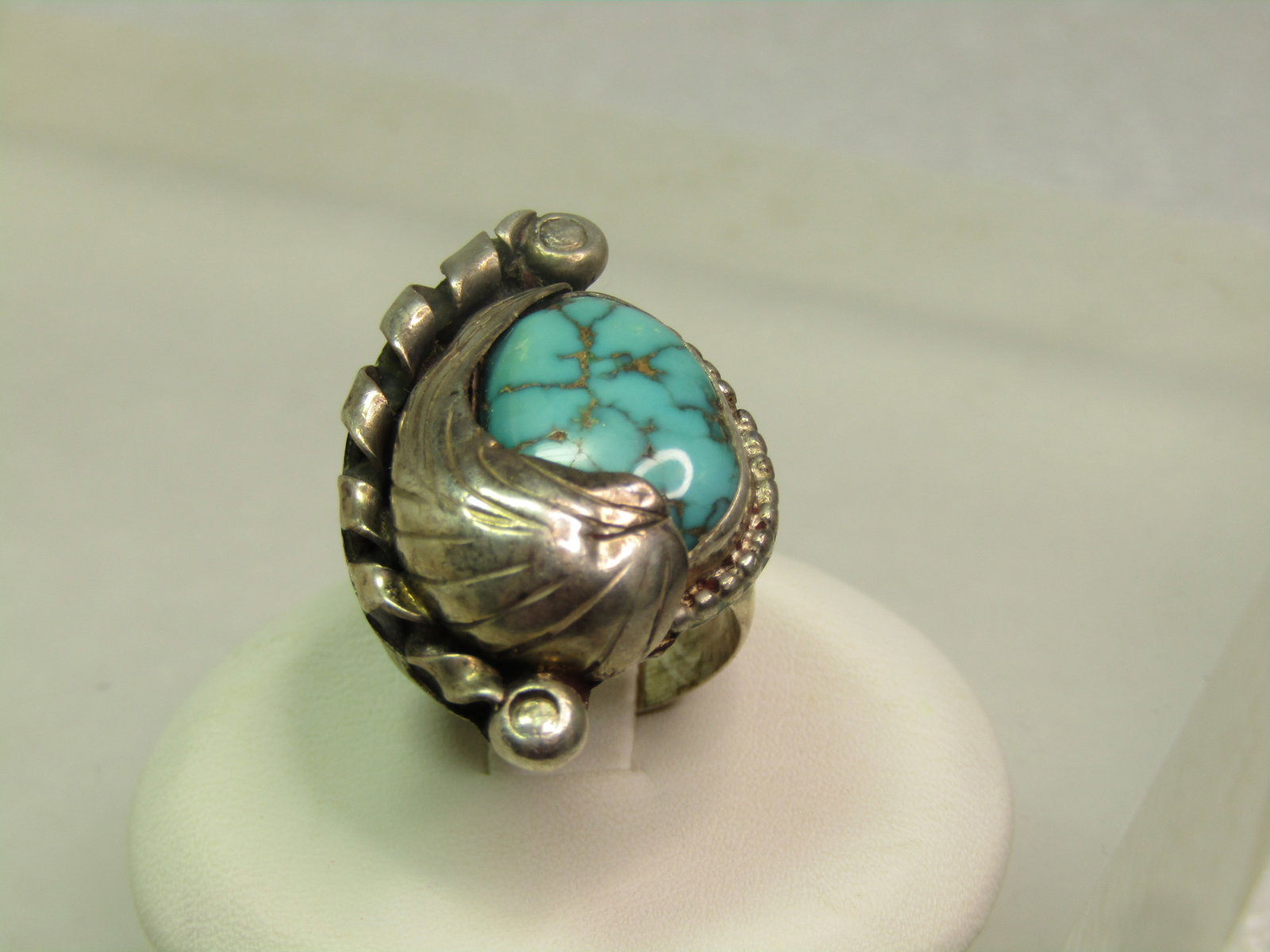 Vintage Sterling Southwestern Turquoise Ring, Feather Accents, Sz. 4.75, 1970's-1980's: Vintage Sterling Southwestern Turquoise Ring, Feather Accents, Sz. 4.75, 1970's-1980's is the estimated age. The turquoise is appx. 14mm by 10mm but given the setting it cannot be measured exactly. It