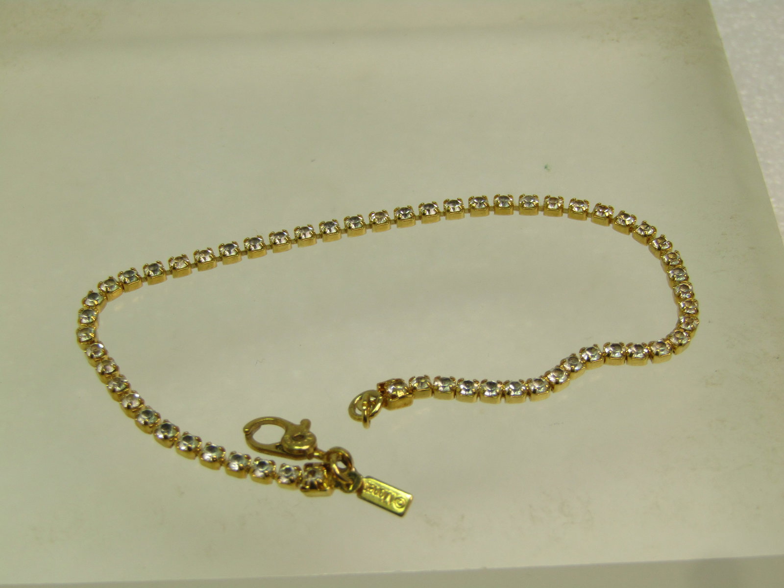 Vintage Clear Rhinestone Bracelet, Signed Money, 1980's. Gold Tone: Vintage Clear Rhinestone Bracelet, Signed Money, 1980's. Gold Tone. This is appx. 2mm wide with a swivel hand-cuff style clasp. It has the Monet tag as well. Very clean and in very good conditon. The 