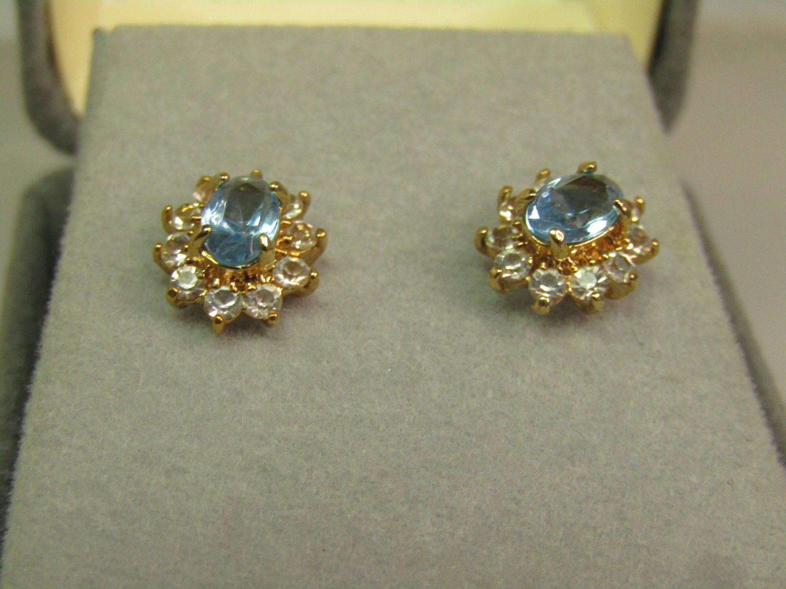 Aqua Blue & Clear Halo Earrings, Pierced Studs, 1980's-1990's: Aqua Blue & Clear Halo Earrings, Pierced Studs, 1980's-1990's. Surgical steel posts and yellow gold tone earrings with a raised aqua blue glass or crystal oval stone that is appx. 5.5mm by 4mm, prong-