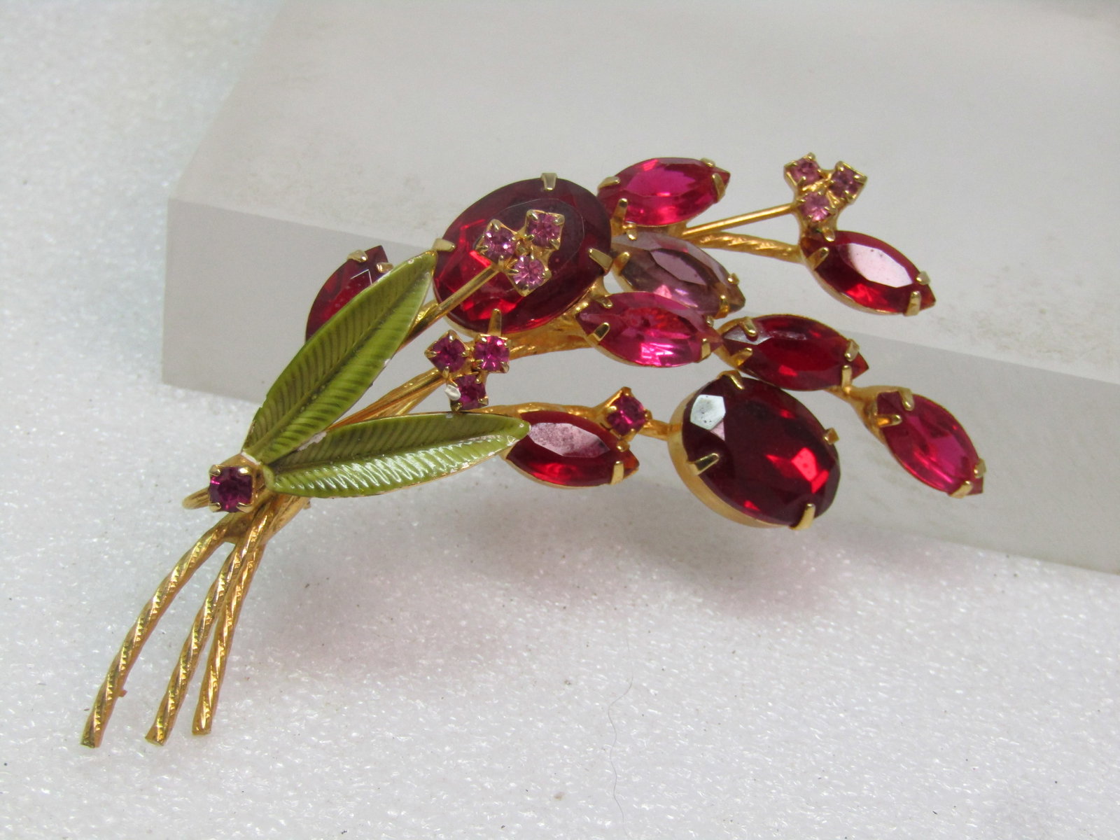 Vintage Red Rhinestone Floral Brooch, Enameled Leaves, 1960's Juliana D&E: Vintage Red Rhinestone Floral Brooch, Enameled Leaves, 1960's Juliana D&E is believed to be the maker. This has open and closed black stones as well as the pinback built into the brooch and not one