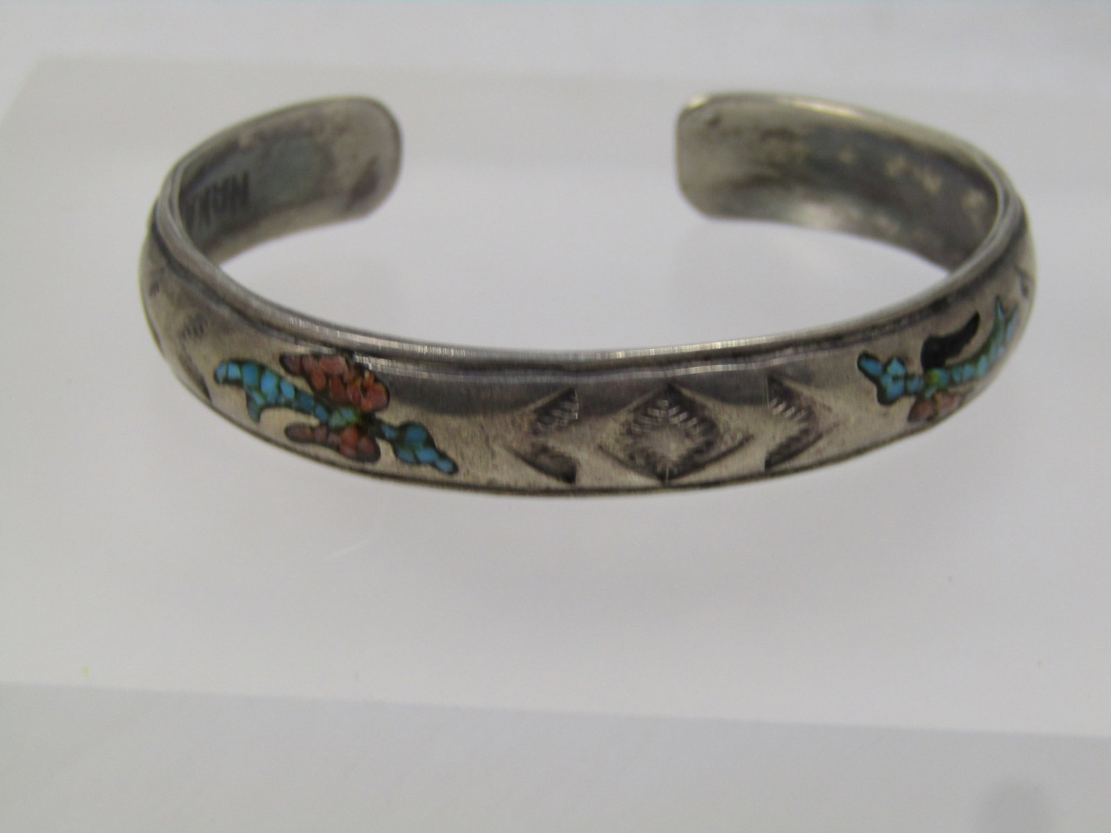 Vintage Sterling Southestern Inlaid Chip Cuff Bracelet, 6", 1960's-1970's, Signed Nakai: Vintage Sterling Southestern Inlaid Chip Cuff Bracelet, 6", 1960's-1970's, Signed Nakai, Navajo. This is domed on the outside with inlaid chips in two birds - the coral chips are missing in the one