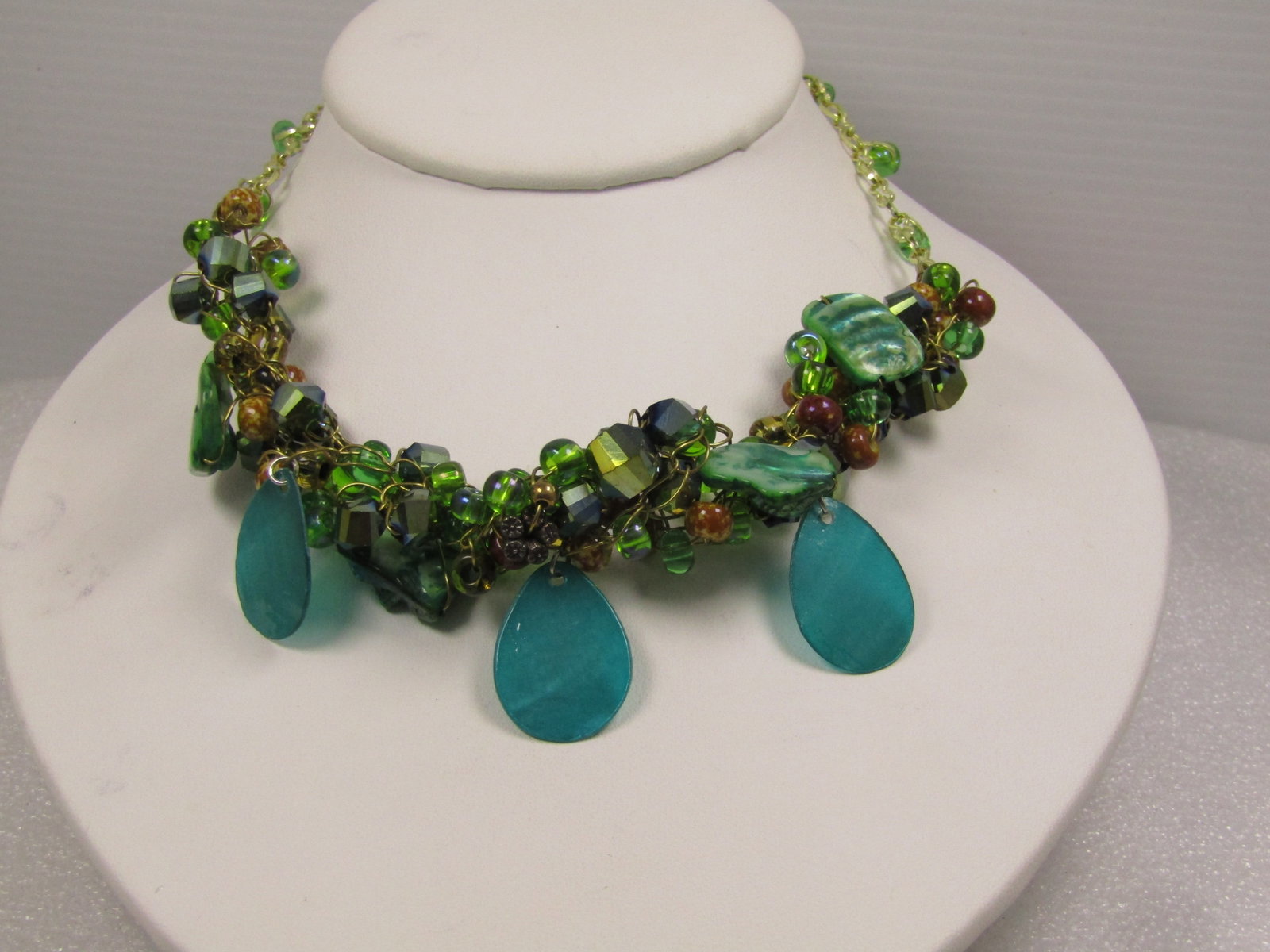 Vintage Teal Dyed Mother-of-Pearl and Crystal Beaded Cluster Necklace, 22", 1980's-1990's: Vintage Teal Dyed Mother-of-Pearl and Crystal Beaded Cluster Necklace, 22", 1980's-1990's. this has a twisted of green, pecock, brown and other beads that are strung on gold tone wire and wrapped arou