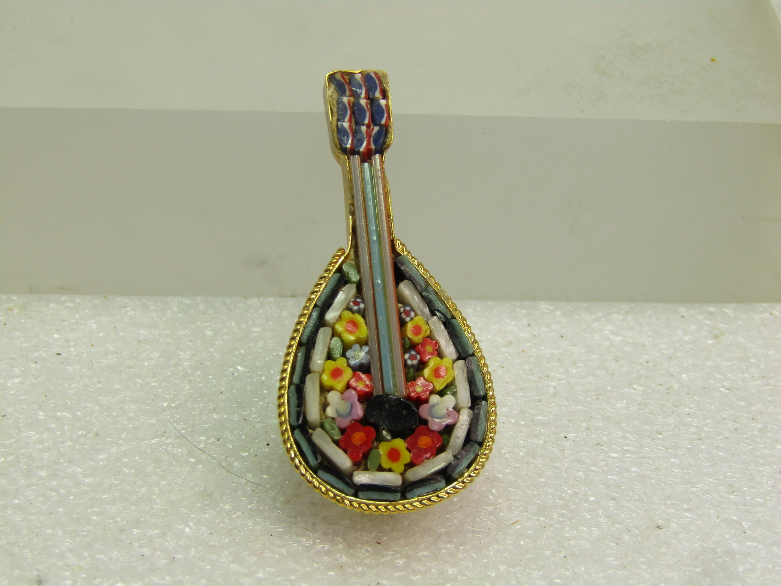Vintage Micromosiac Mandolin Brooch, Italy, 1960's-1970's: Vintage Micromosiac Mandolin Brooch, Italy, 1960's-1970's. This is made of small glass pieces creating the floral mosaic and longer strips of glass for the mandolin strings going up the neck of the