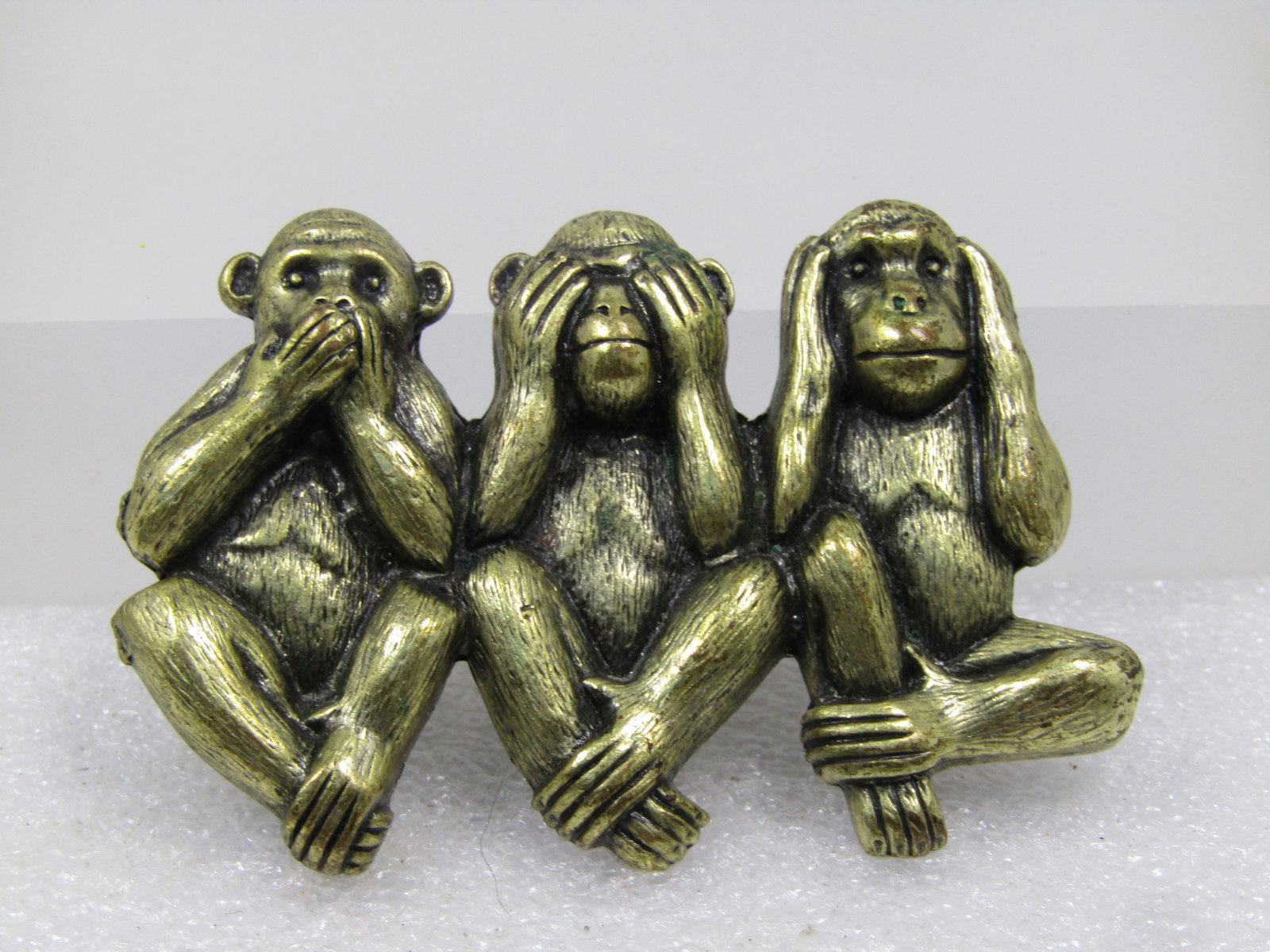 Vintage Speak See Hear No Evil Monkey Brooch, 1980's: Vintage Speak See Hear No Evil Monkey Brooch, 1980's. This is a black washed brassy gold tone brooch with the three monkeys sitting side-by-side, one with the mouth covered, one the eyes, and the othe