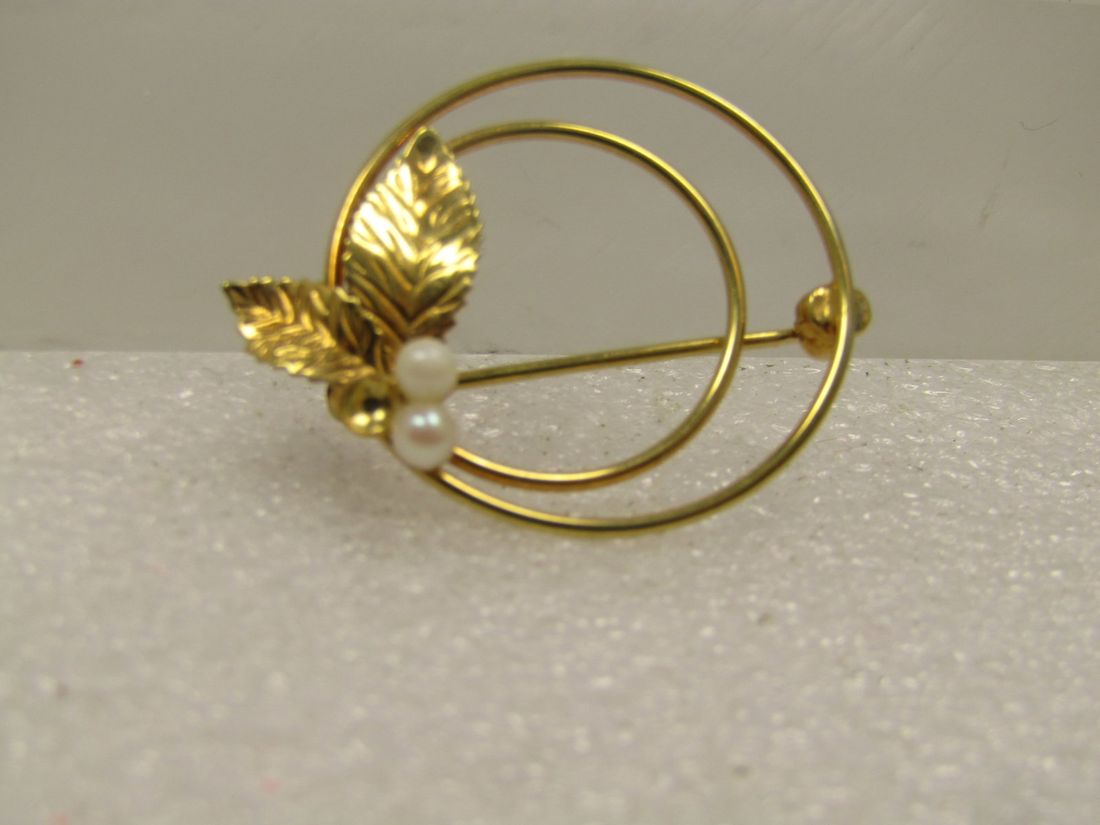 Vintage 12kt GF Faux Pearl Brooch, Leaf Accents, Signed Carla, 1960's: Vintage 12kt GF Faux Pearl Brooch, Leaf Accents, Signed Carla, 1960's. This has two faux pearls that are appx. 3mm with two leaves set on the one side of the brooch. This has two circles, a smaller on