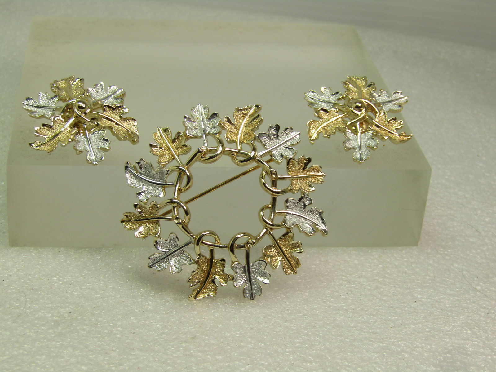 Vintage Sarah Coventry Circle Leaf Brooch & Clip Earrings, Two-Tone, 1970's: Vintage Sarah Coventry Circle Leaf Brooch & Clip Earrings, Two-Tone, 1970's. The leaves alternate between silver tone and gold tone. The brooch is appx. 1.75" round and the clips earrings are appx. 1.
