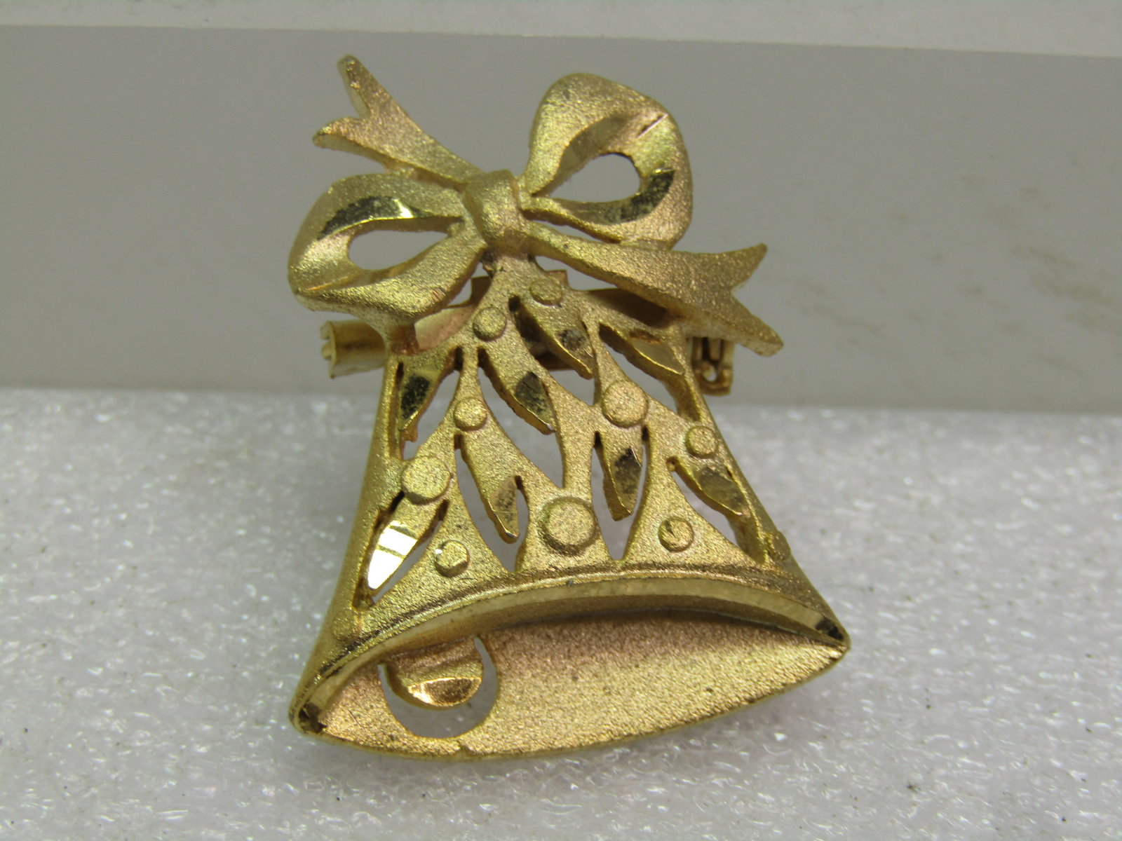 Vintage Bell Brooch, 1960's-1970's, Gold Tone, Christmas: Vintage Bell Brooch, 1960's-1970's, Gold Tone, Christmas. This has a cutout design with accents of pointed cut-outs and raised round accents - mostly a textured finish with some shiny and smooth