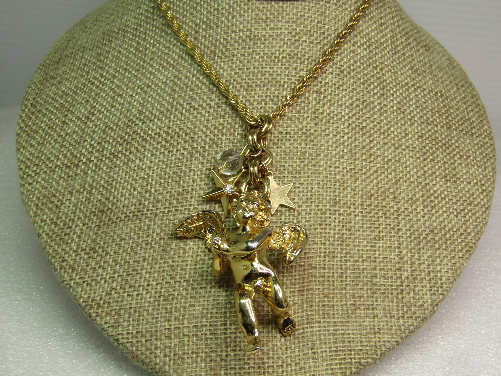 Vintage Kirk's Folly Cherub Star Pendant on 18" Chain, 1990's: Vintage Kirk's Folly Cherub Star Pendant on 18" Chain, 19. This is a gold tone cherub with hands togetherr with an appx. 1" double wide link chain abot with an aurora borealis 8mm faceted crystal