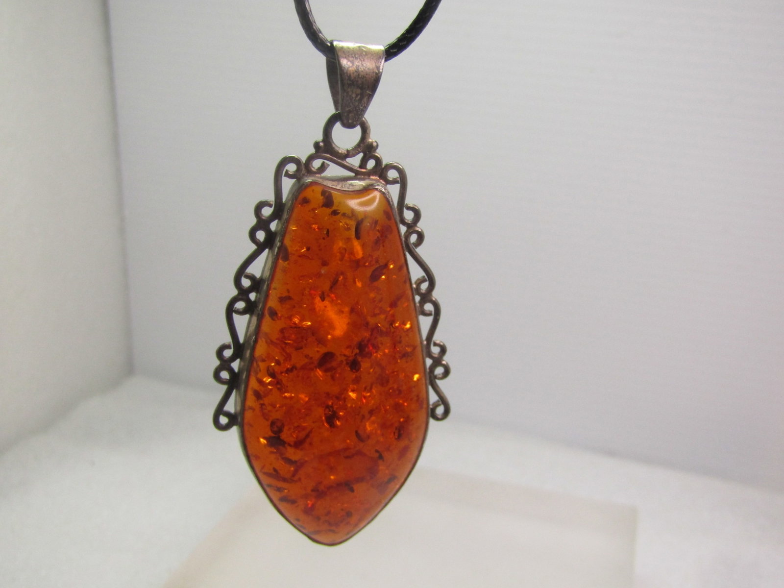 Vintage Sterling Baltic Amber Pendant/Necklace, 26", 1970's-1980's: Vintage Sterling Baltic Amber Pendant/Necklace, 26", 1970's-1980's. Filgiree frame around slightly more than a half of the bezel-set amber. The pendant is appx. 3" tall and just slightly under 1.5" wi