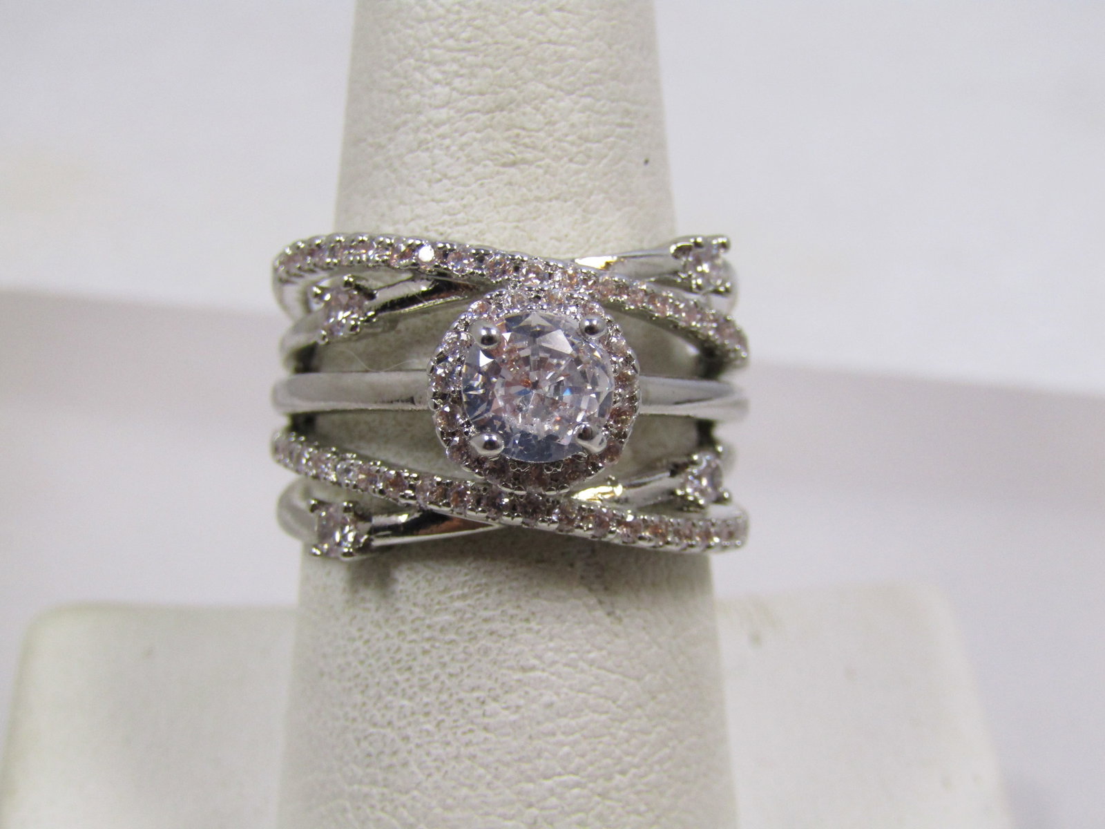 Silver Tone Clear Rhinestone Five Band Crisscross Ring, Sz. 8.5, Modern: Silver Tone Clear Rhinestone Five Band Crisscross Ring, Sz. 8.5, Modern. This is marked .925 but it is not sterling. It is a silver tone costume ring - wide statement ring with five band, two have cle