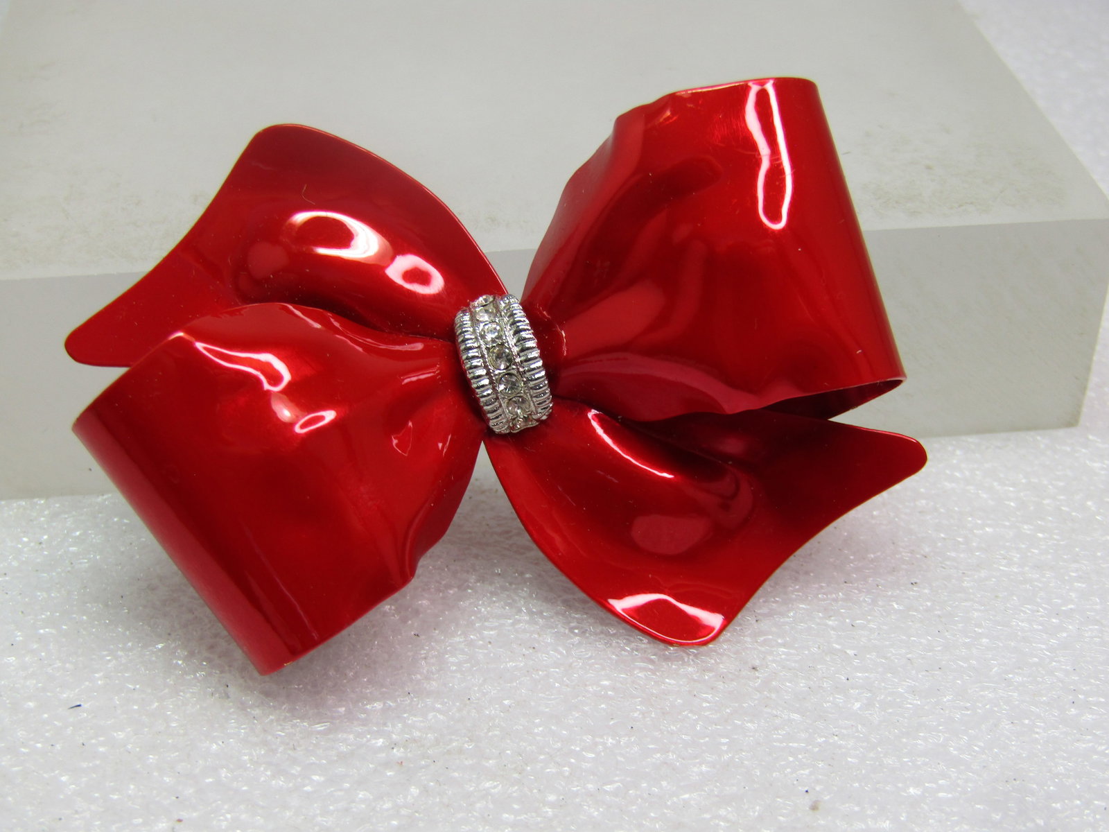 Vintage Red Enameled Bow Brooch, Clear Rhinestones, 1980's: Vintage Red Enameled Bow Brooch, Clear Rhinestones in the silver tone center gather. The red enameling has a brighter red metallic appearance. It is a 3-D blow and not flat. It is appx. 2.25" tall and
