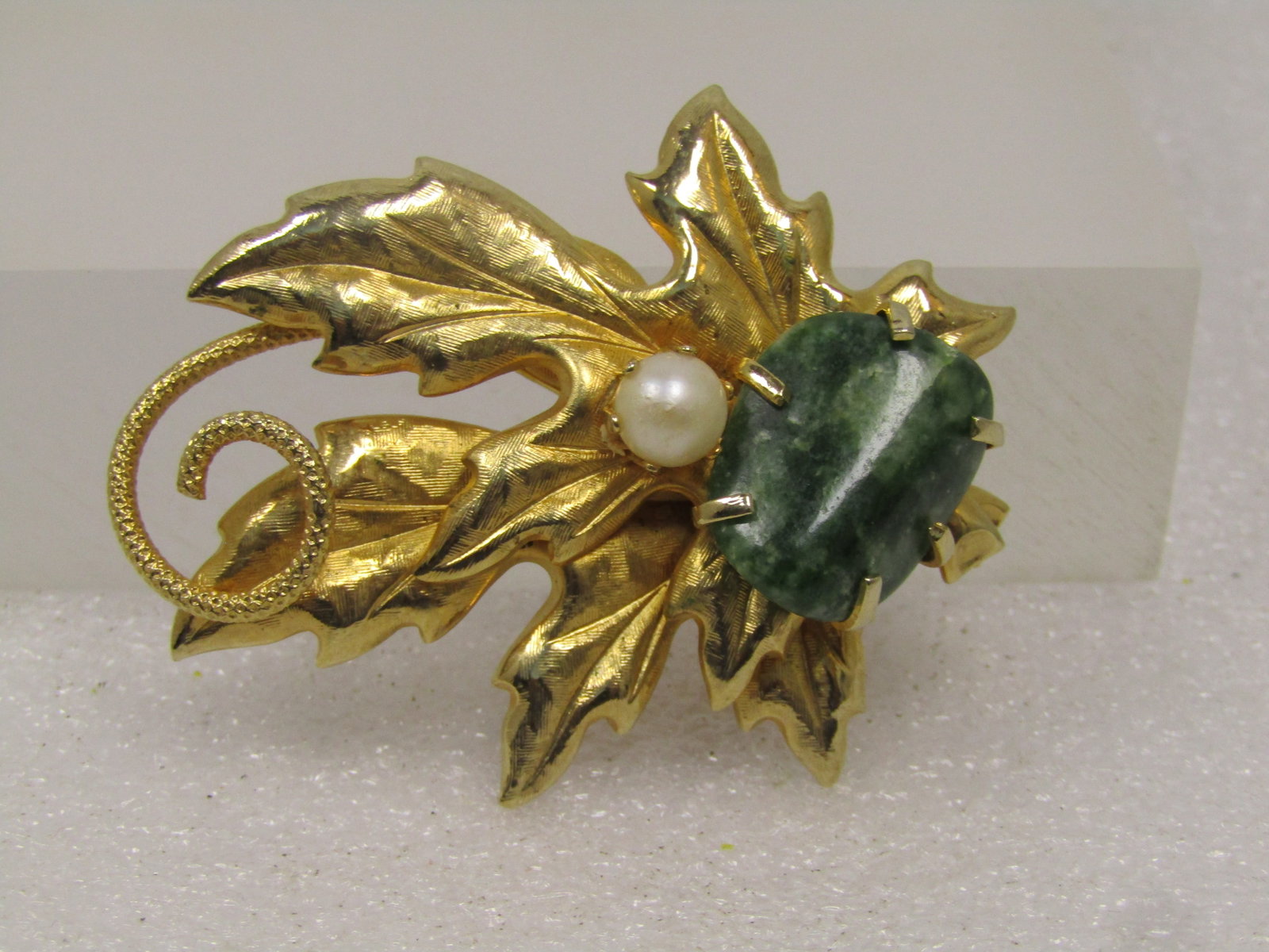 Vintage Green Agate Faux Pearl Leaf Brooch, 1960's-1970's: Vintage Green Agate Faux Pearl Leaf Brooch, 1960's-1970's. This has two leaves, one partially over the other in a satiny textured finish and a coiled tip. The gate is held with five prongs and is appx