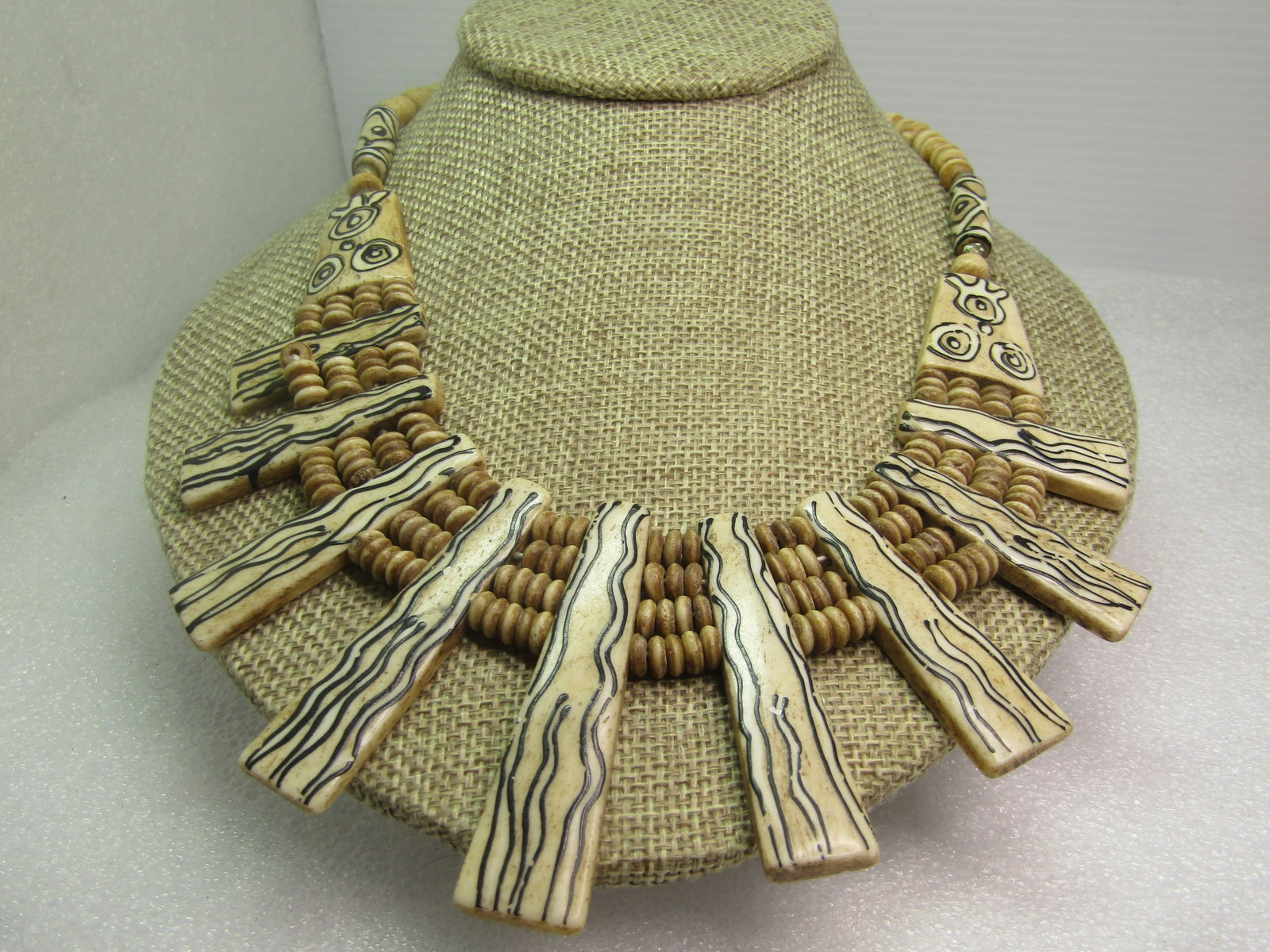 Vintage Painted Bone Beaded Necklace, Tribal, 18", 1970's-1980's: Vintage Painted Bone Beaded Necklace, Tribal, 18", 1970's-1980's. Off white bne beaded necklace that has tapered drops with black and white painted tribal designs as well as on the ends caps and long