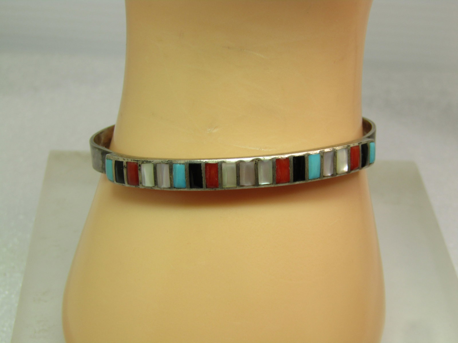 Vintage Sterling Southwestern Inlaid Cuff Bracelet, Mixed Stones, 6.75", 1970's: Vintage Sterling Soutwestern Inlaid Cuff Bracelet, Mixed Stones, 6.75", 1970's. This is a heavy sterling band with a row of inlaid turquoise; onyx; carnelian' and white and pink mother-of-pearl set in