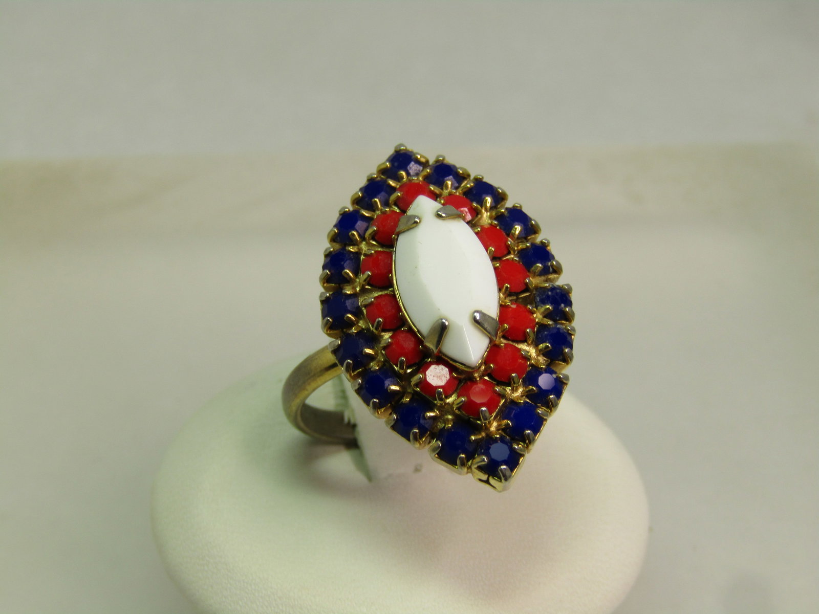 Vintage Red/White/Blue Glass Stone Ring, Adjustable to Sz. 6, 1960's-1970's: Vintage Red/White/Blue Glass Stone Ring, Adjustable to Sz. 6, 1960's-1970's. The outer frame is blue, center row red with a large white stone on top. Cateye shaped ring that is gold tone and appx.
